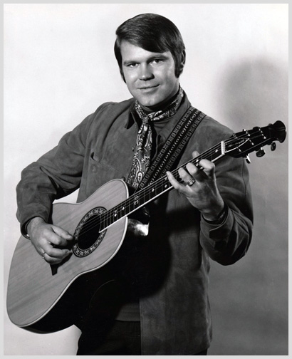 Glen Campbell holding one of the guitars he frequently enjoyed making memorable tunes with.